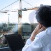 office-manager-stares-out-window-at-crane-operator-and-regrets-all-life-choices